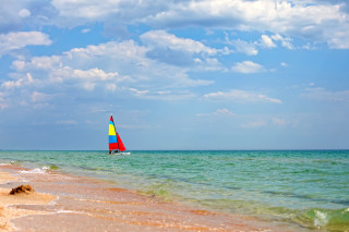 Sailboat ocean sunny day blue - a few wave free wallpaper