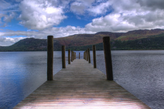 Lake dock poles mountains sky - a few pole free wallpaper