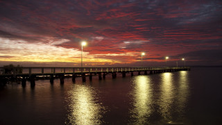 Pier lights night red sky - a red sky in the background free wallpaper