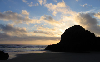 Rock formation beach sunset clouds - a rock formation free wallpaper