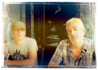 Two men sitting table food 2 - a plate of food in front free wallpaper for desktop