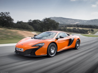 Orange sports car driving hills - a orange sports car free wallpaper
