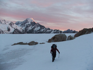 Person walking snowy hill backpack - liminal space free wallpaper