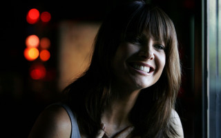 Woman smiling window night traffic - daphne allen free wallpaper