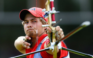 Man holding bow aiming red - bow free wallpaper