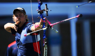 Man holding bow aiming arrow - mitchell mohrhauser free wallpaper