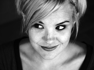 Woman messy bun black eyes - freckle free wallpaper