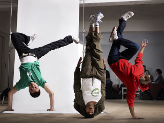 Three boys handstand white wall - three person free wallpaper
