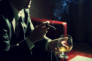 Man suit smoking cigarette holding - his hand and a cigarette free wallpaper