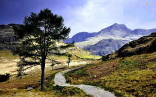 Winding path grassy valley mountains - ada hill walker free wallpaper