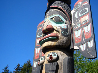 Totem statue blue sky trees - derek chittock free wallpaper