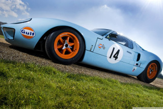 Blue racecar orange wheels dirtroad - hard edge free wallpaper
