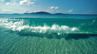 Breaking wave ocean small island - a small island in the distance free wallpaper