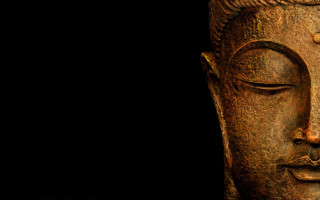 Buddha statue closeup black background 4 - facial feature free wallpaper