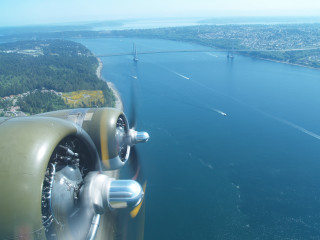 Propeller plane flying water bridge - a bridge in the distance free wallpaper for desktop