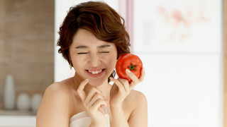 Woman holding tomato smiling camera - both hand free wallpaper for desktop