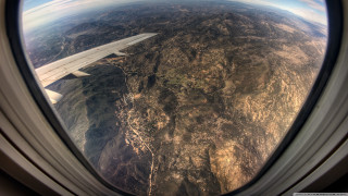 Mountain airplane window view ground - an airplane window free wallpaper for desktop