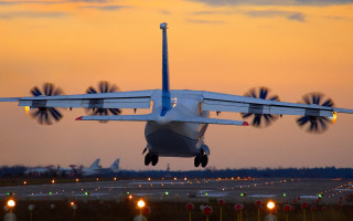 Plane taking off runway sunset - motion blur free wallpaper