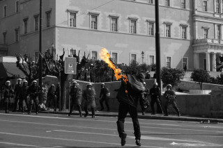 Man running street fire stick - ai weiwei free wallpaper
