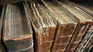 Old books wooden table pile - flemish free wallpaper