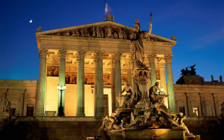Building statue nighttime full moon - a statue in front free wallpaper