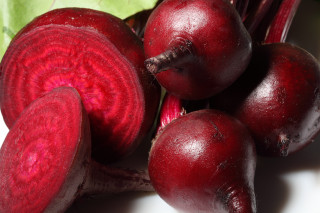 Red vegetables closeup table leaves - a white surface free wallpaper for desktop