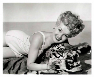 Woman holding stuffed tiger smiling - a pillow free wallpaper