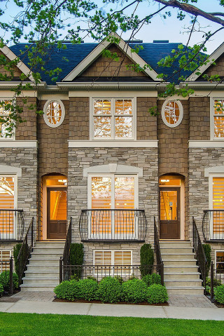 Brick houses with clocks front - free architecture wallpaper for mobile