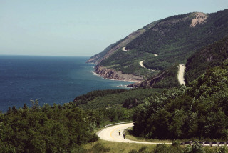 Winding road ocean view mountains - a bicycle free wallpaper