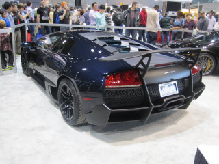 Black sports car showroom crowd - a showroom free wallpaper