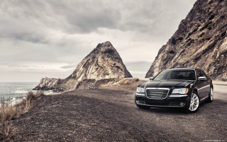 Black car mountain range water 2 - a black car free wallpaper