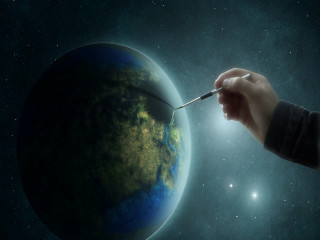 Hand holding paintbrush planet stars - a planet free wallpaper