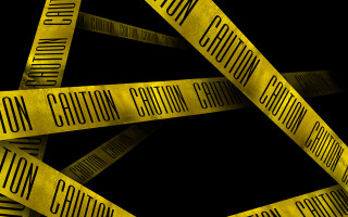 Caution tapes triangle black background - a yellow border free wallpaper
