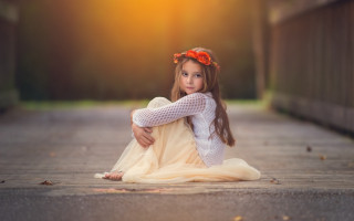 Little girl sitting arms crossed - a white sweater free wallpaper