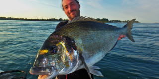 Man holding large fish boat - a large fish free wallpaper