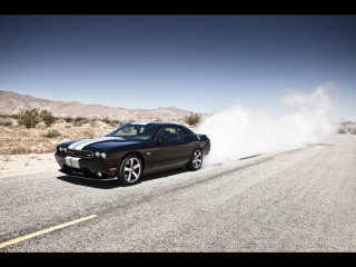 Black car driving dusty road - dust free wallpaper
