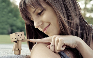 Woman holding wooden toy figure - single body free wallpaper