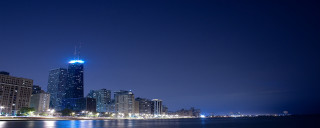 City skyline night water tall - a large body of water in front free wallpaper