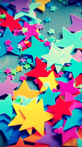 Colorful stars tabletop black background - free abstract wallpaper for mobile