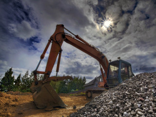 Large machine digging rocks cloudy - the sun free wallpaper
