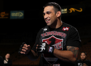 Man holding black object smiling - deep shadow free wallpaper