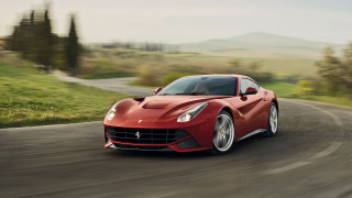 Red sports car countryside road - a blurry background of trees and grass free wallpaper