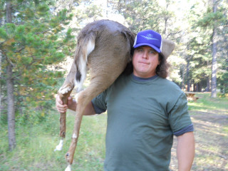 Man holding deer forest trees - live action free wallpaper