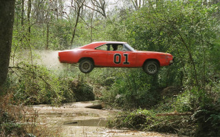Red car jumping muddy stream - muddy free wallpaper