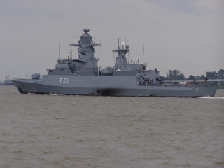 Battleship water forest hillside cloudy - front view free wallpaper