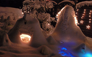 Snow covered lit tree building - area free wallpaper