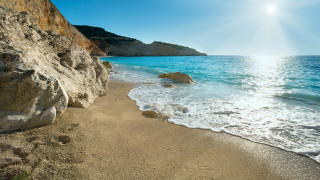 Sandy beach cliff water sun - a sandy beach free wallpaper
