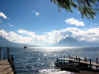 Boat docked pier lake mountains - the background and a boat free wallpaper