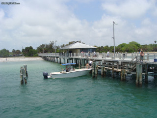 Boat docked pier people water - a pier free wallpaper