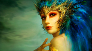 Woman blue gold feather headdress - front of her face free wallpaper
